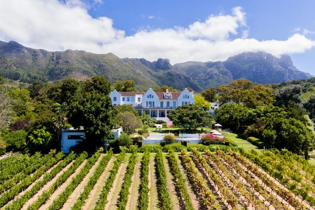 The Cellars Hohenort Hotel Exterior with Mountains in Background