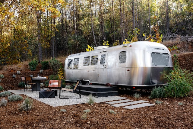 Static home with outdoor seating surrounded by trees
