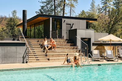 group of men and women sitting by a pool