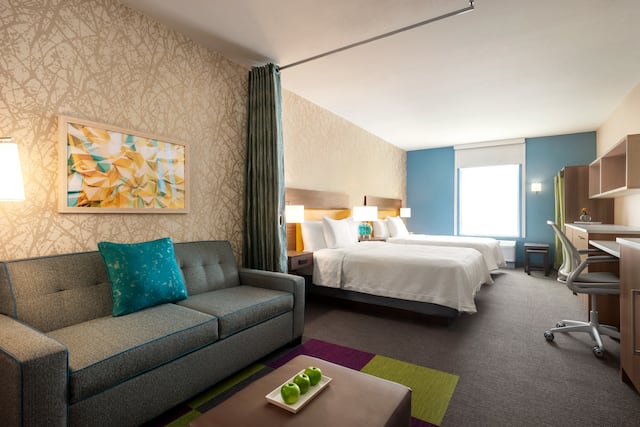 Brand Approved Placeholder Image of a studio suite with sofa, two queen beds, and work desk