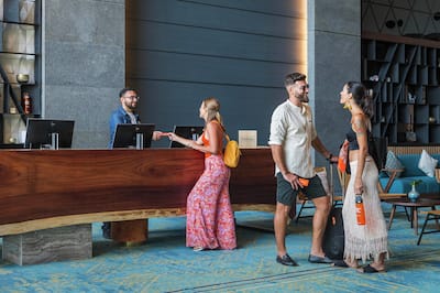 Guests waiting at a stylish reception desk and lounge.