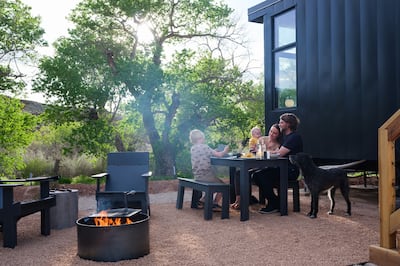 Cabin exterior with young family and dog