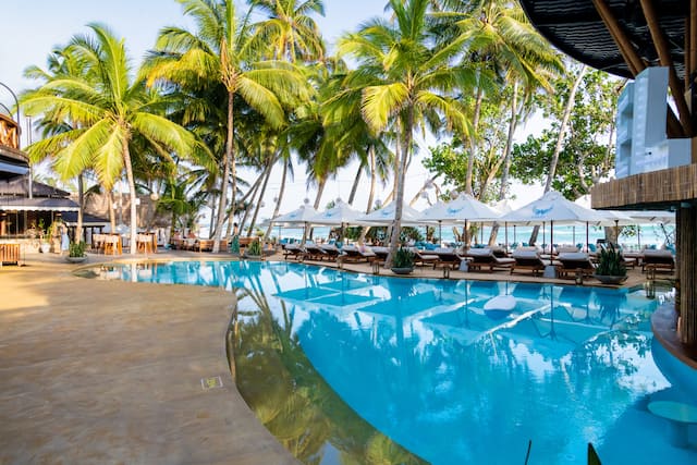 Outdoor swimming pool with loungers and parasols