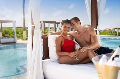 Couple in Cabana at Poolside with Champagne shot 1