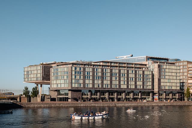 view of hotel and people in a boat from water