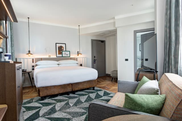 Junior suite bedroom with couch and TV