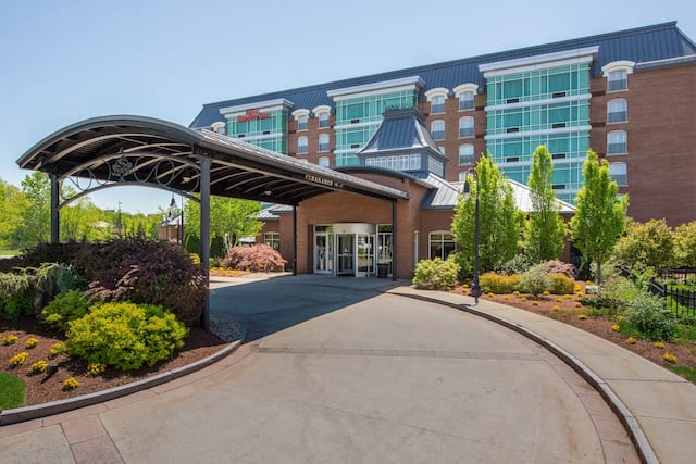 Hotel exterior with driveway and trees