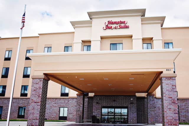 Front hotel exterior with circle drive under covered entrance