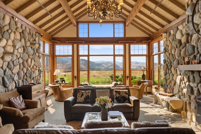 Seating area in lobby with large window looking over grassland