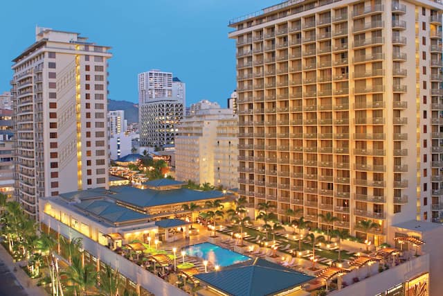 Aerial View Hotel Exterior in the Evening with Swimming Pool