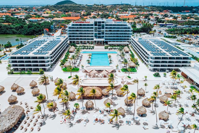 Front view of hotel building outdoor pool and beach area