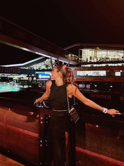 woman posing for photo near race track