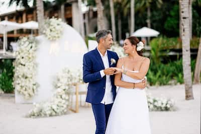 A newly married couple gaze into each other's eyes