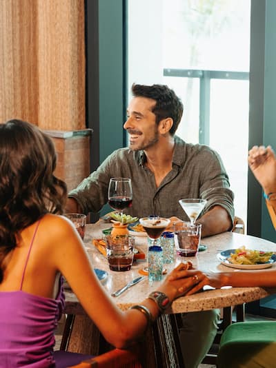 Two happy couples enjoying dinner and drinks in a restaurant