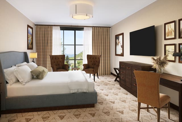 Large Bed, HDTV, Work Desk and Sitting Area in a Guest Room