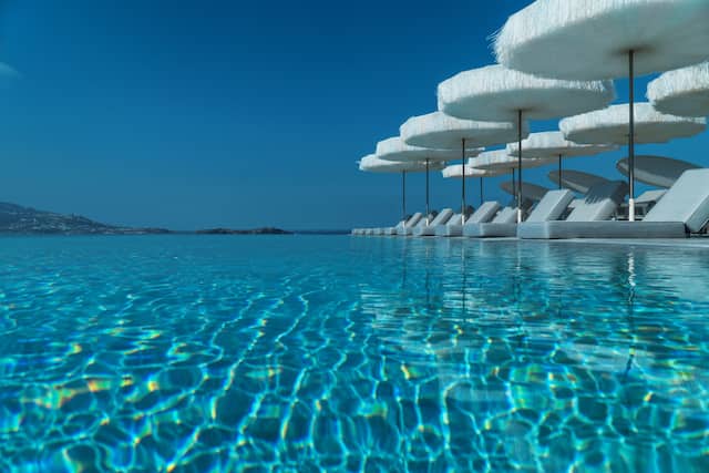 Infinity pool with loungers and parasols