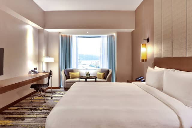 Large Bed, TV, Desk and Sofa in a Guest Room