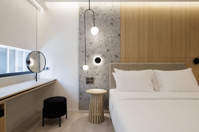 Guestroom with Comfortable Bed and Vanity Area