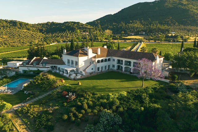 Aerial View of Hotel Casa Palmela Exterior with Mountains in Background