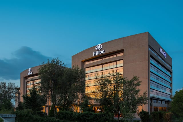Hotel Exterior with Illuminated Signage at Dusk