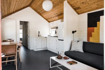 Cabin interior with table, chairs and kitchen area