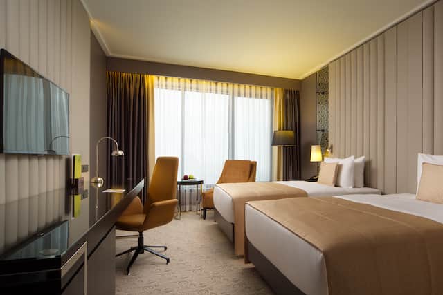 Twin Guest Room with Wall Mounted TV and Work Desk