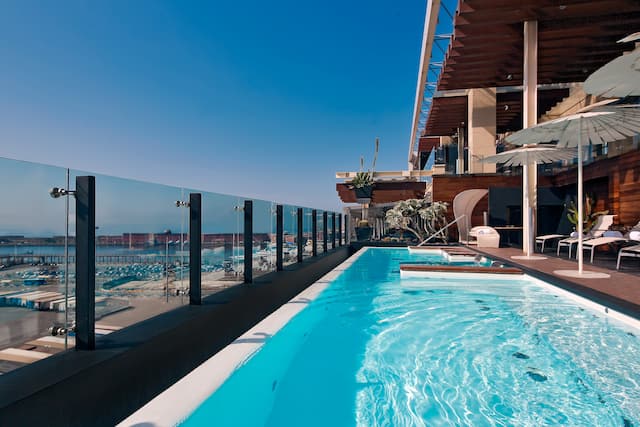 Rooftop pool with loungers