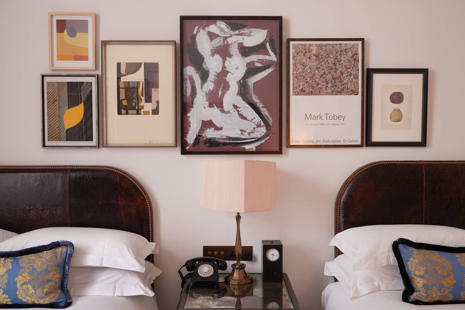 Two beds in room with lamp and telephone