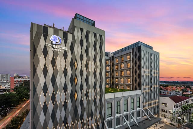 Hotel exterior with signage and surrounding buildings