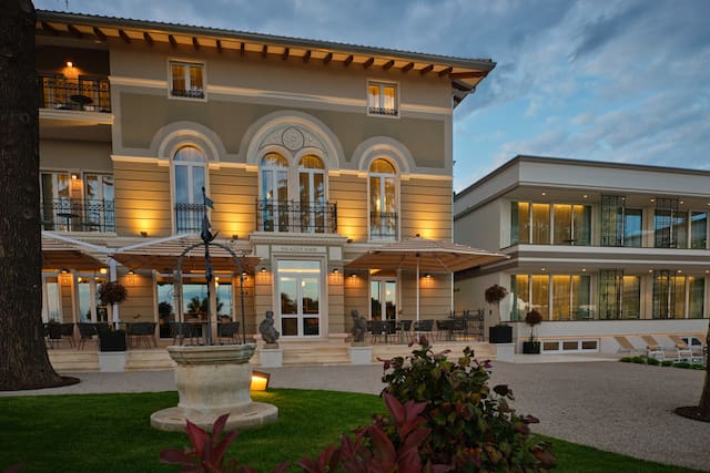 Hotel exterior with surrounding trees and ornamental detail