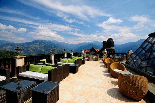 Rooftop lounge area with tables and chairs