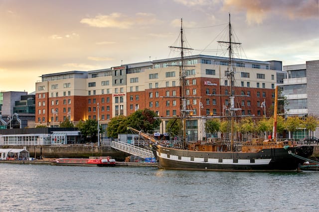 Hotel Exterior with View of Boats on River Liffey
